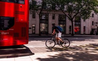 cyclist behind London bus
