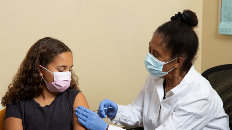girl receiving a  vaccine
