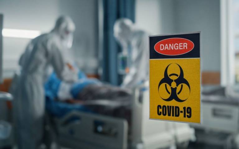 Hospital room with a  sign of COVID risk