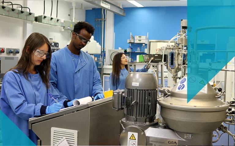 3 scientists in pilot plant blue lab coats