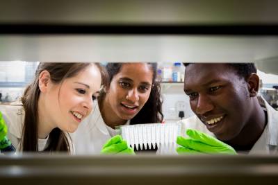 three students in biosciences lab