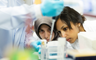 two women in a lab taking samples