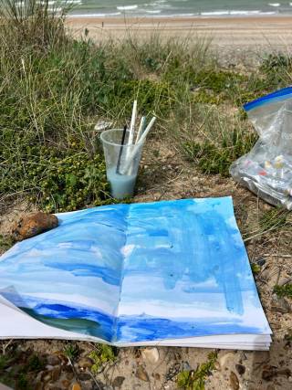 A book with blue and white drawing on the ground