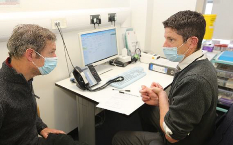 a man getting examined by a doctor 