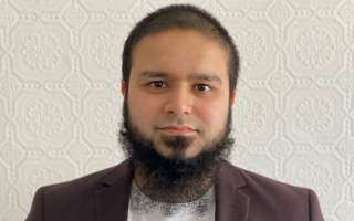 Picture of Imran Uddin, Imran has short dark hair and a beard and is in front of a white background.