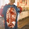 Image of student holding shirt with coloured x-ray image 