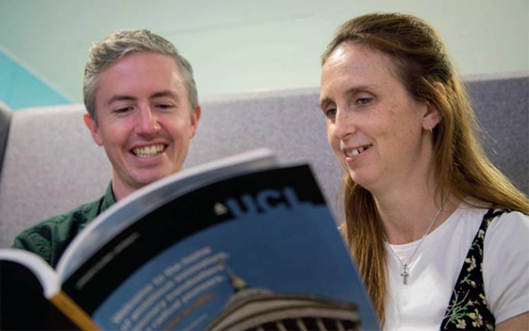 Two people looking at a booklet