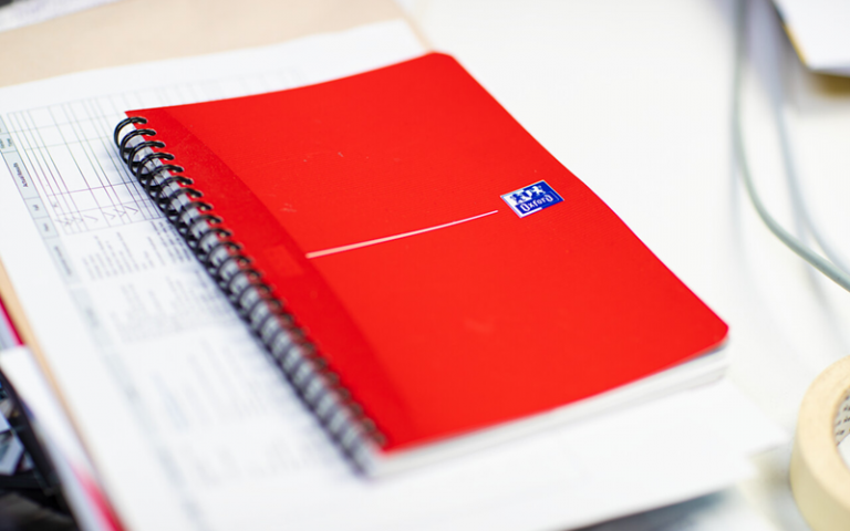 Red notebook on a desk