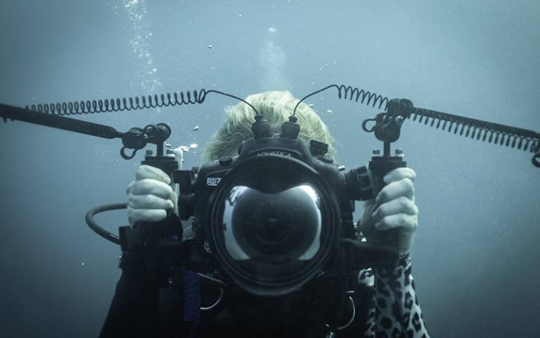 Love The Oceans Managing Director Francesca in the ocean with a camera.