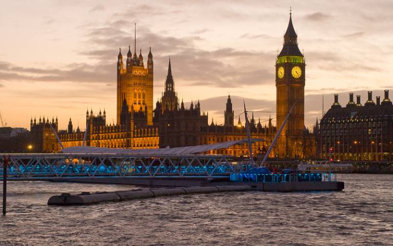 The Houses of Parliament & Big Ben amid sunset behind the River Thames.