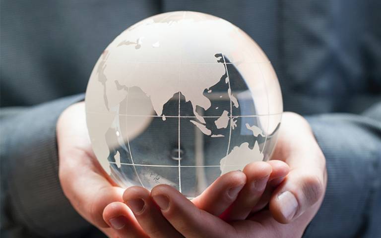 Man holding glass globe in hands