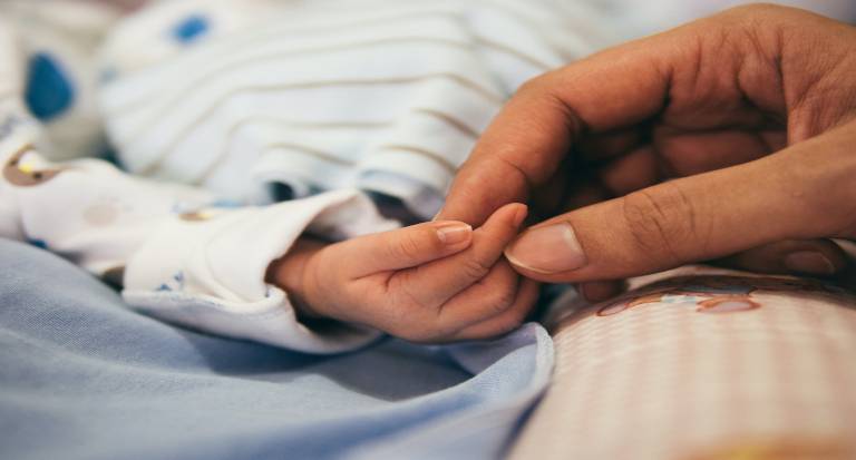 echild infant hand holding