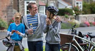 Image of family cycling