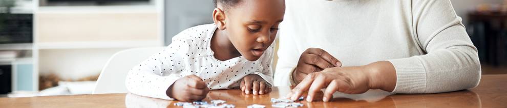Mother and child playing with jigsaw
