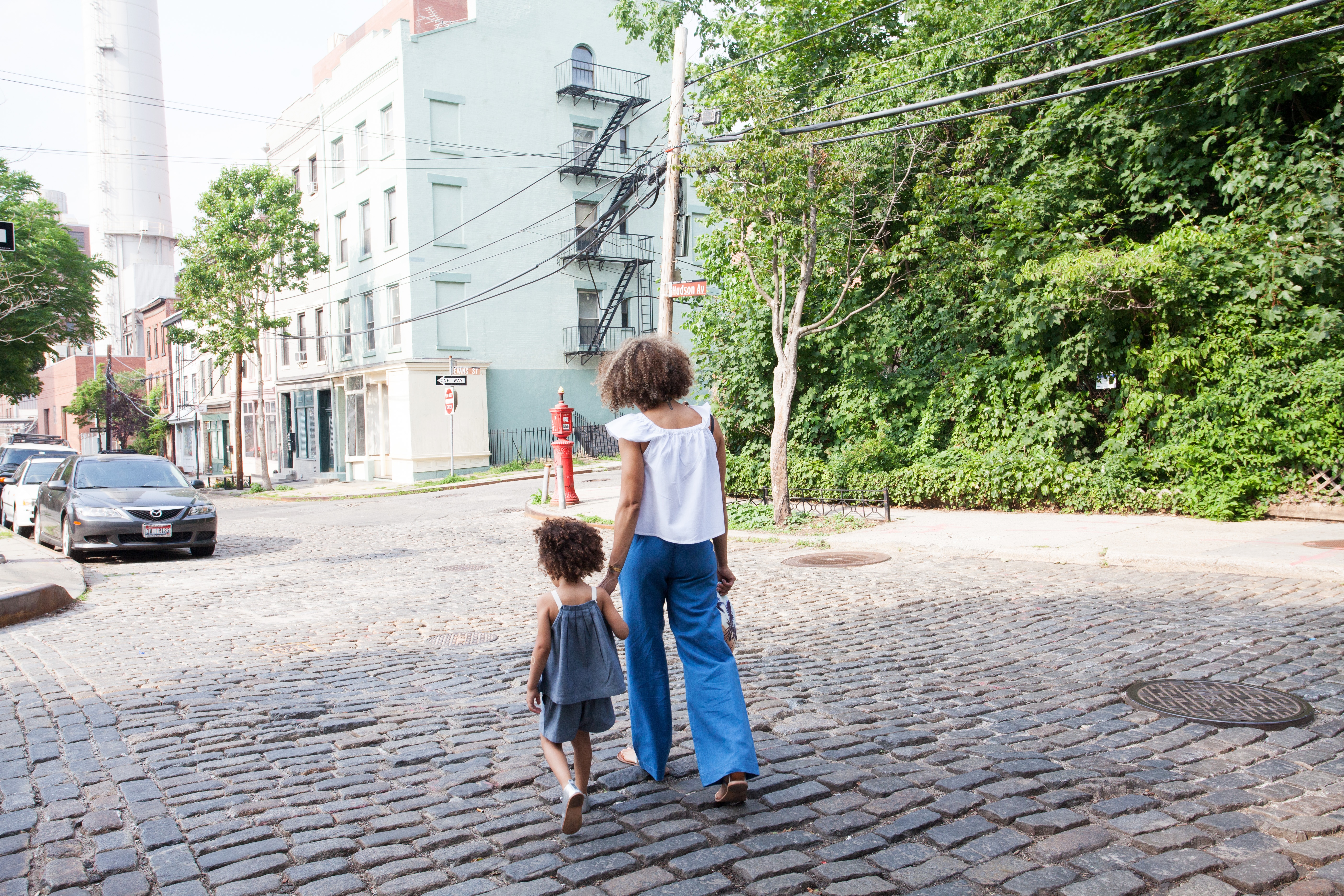 Woman and child walking down a New York side street