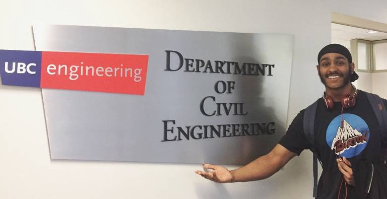 A picture of student Amarpreet next to the University of British Columbia's Civil Engineering Department sign
