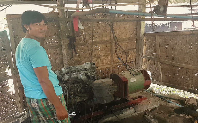 Aung Moe Win, one of Myanmar’s rural electricians, or meesayars, with his village’s electricity generator which he created himself 20 years ago. Photo credit: Mee Panyar 