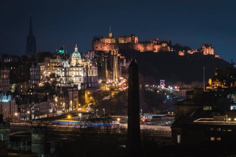 A view of Edinburgh castle and the city at night.