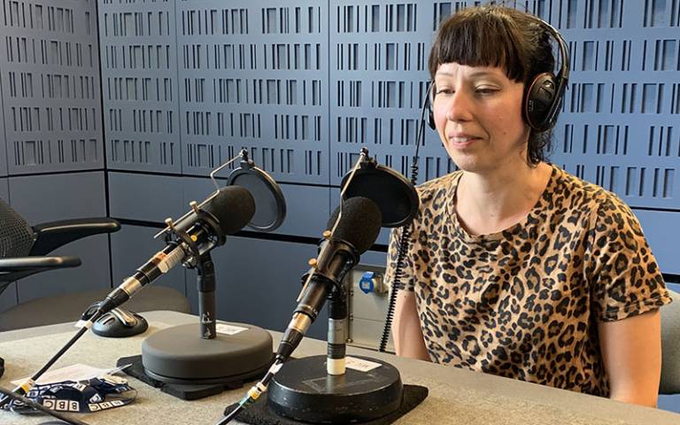 Dr Lena Ciric in front of radio microphones in a BBC studio. 