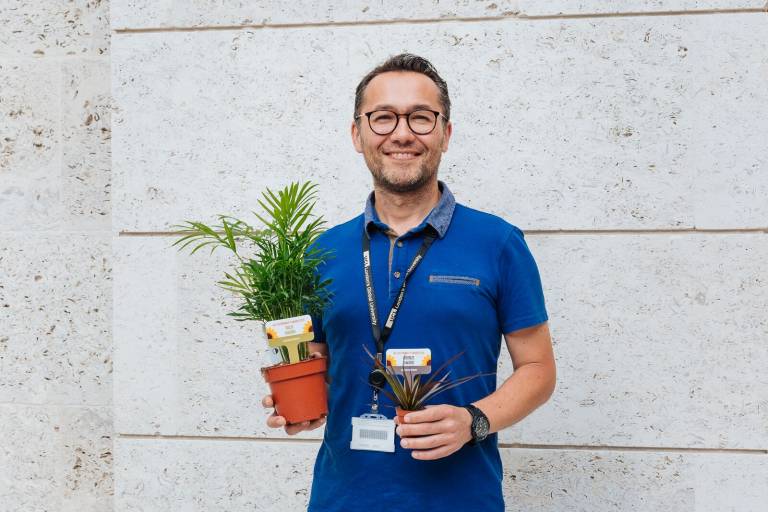 Dr Utku Solpuker, CEGE's environmental laboratory technician, with two plants awarded at the UCL Sustainability Research Awards ceremony 2019