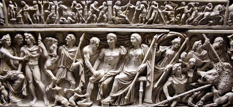 white marble relief of many people, weapons and a boar