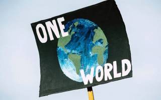 Climate protest poster that reads 'One World'