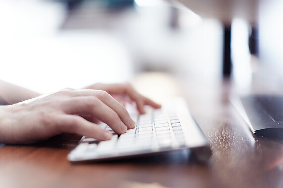 image of hands typing on a keyboard leading onto the Accessible remote meeting guidelines page