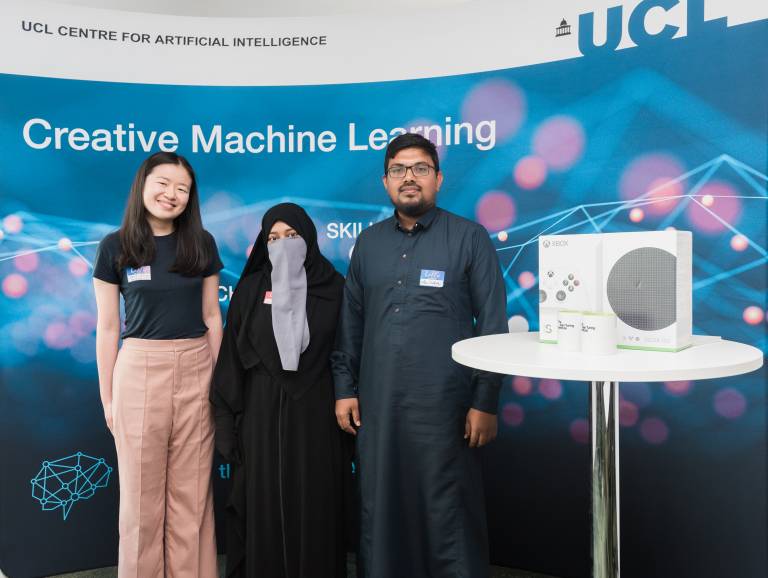 Image of two competition winners and Alan Institute member