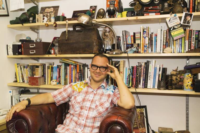 Cory Doctorow in his study, surrounded by books and trinkets