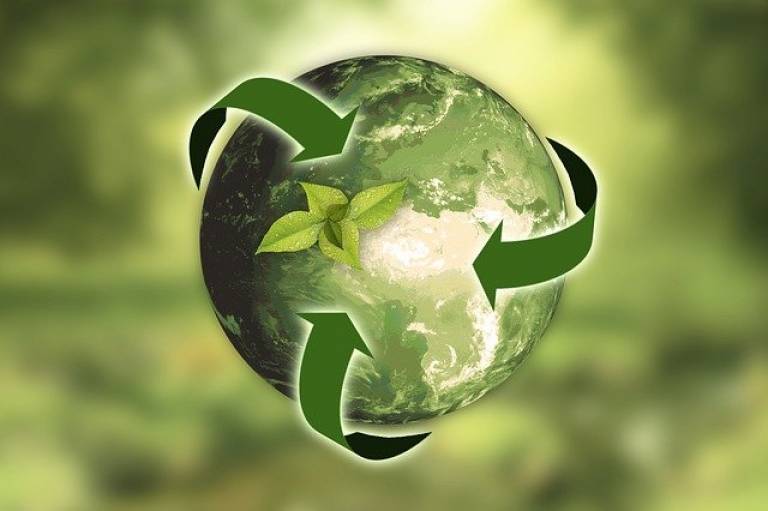 Green image featuring green globe, and recycling arrows