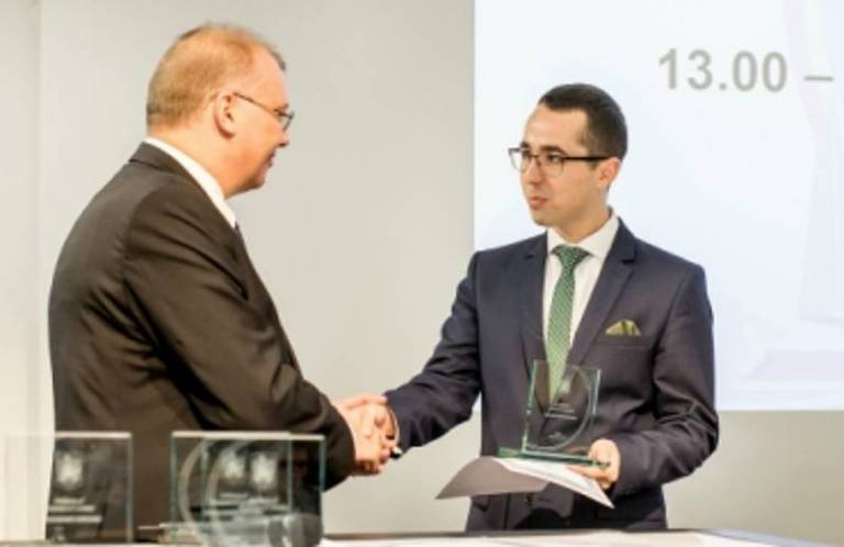 Andrei Margeloiu receives his award from Romanian Ambassador Dan Mihalache on Friday 3 November 2017.