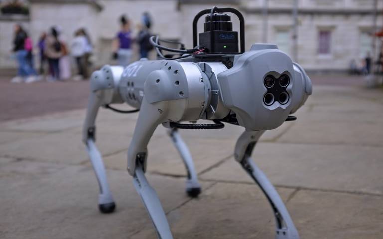 Silver quadruped robot on UCL campus 