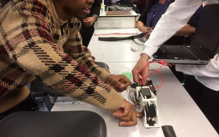 students experimenting with a robotics device