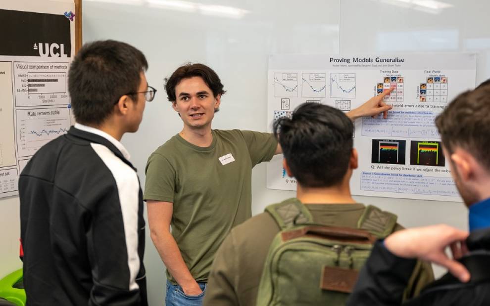 a UCL Computer Science PhD student giving a poster presentation