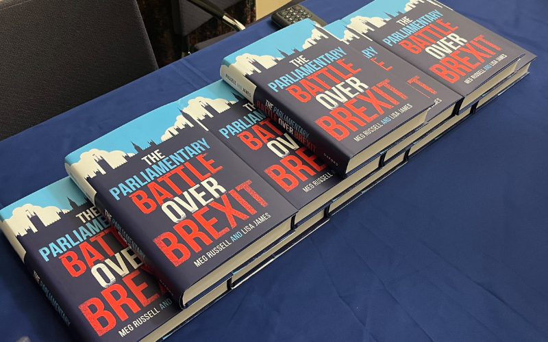 A stack of copies of 'The Parliamentary Battle over Brexit' by Meg Russell and Lisa James.