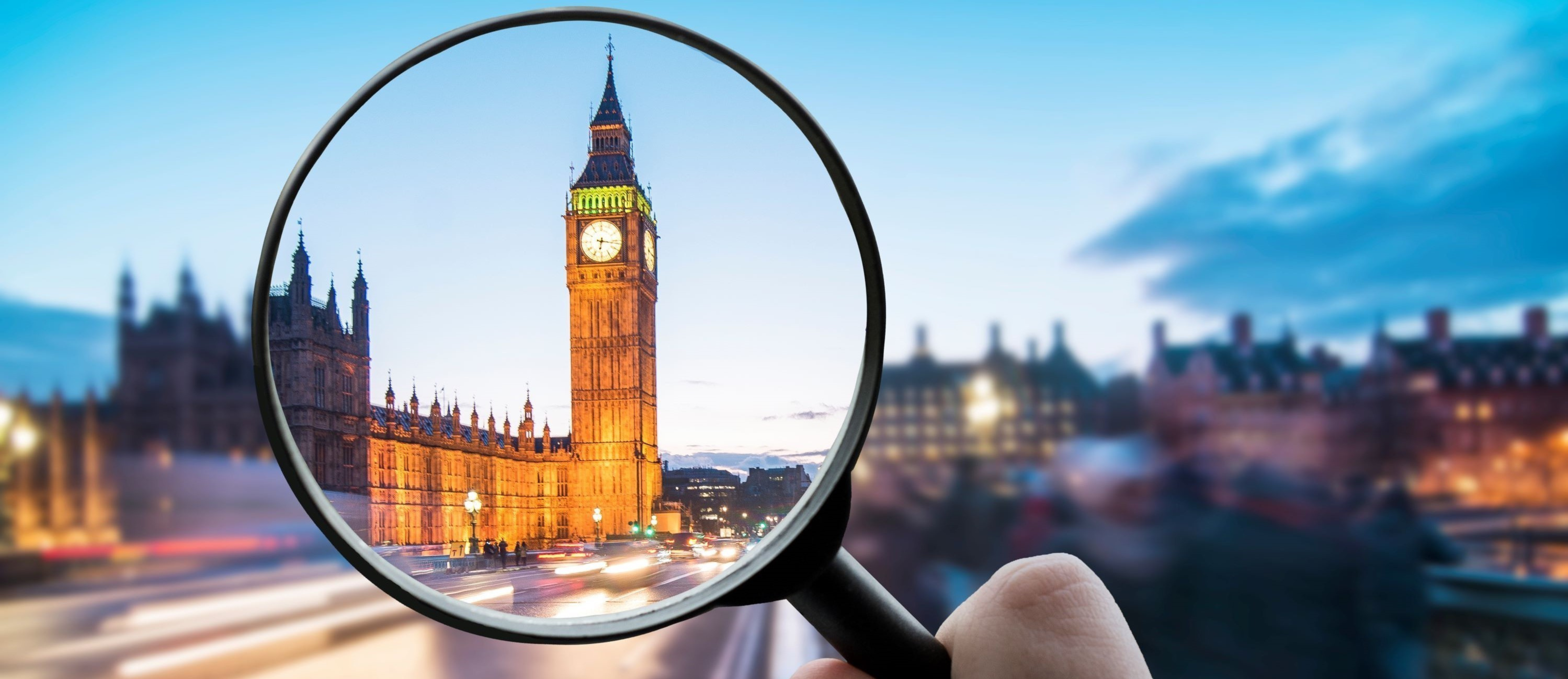 A blurred Palace of Westminster with a magnifying glass hovering over a clear section