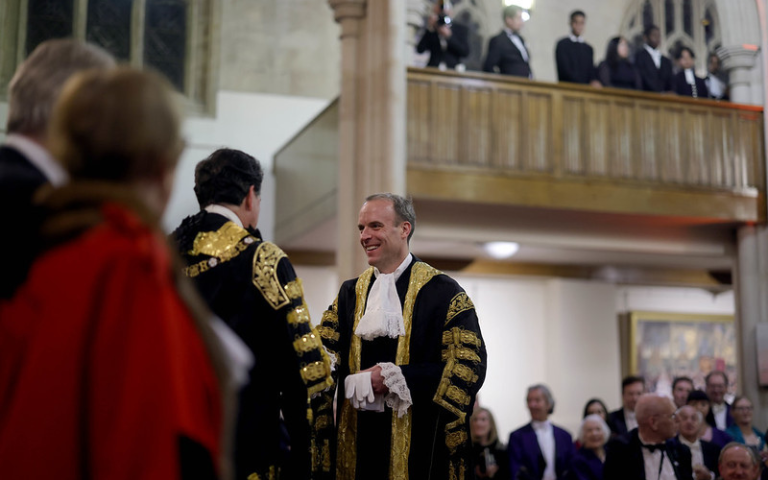Dominic Raab, Lord Chancellor wearing a gold and black robe, shaking hands with another man in a gold and black robe.