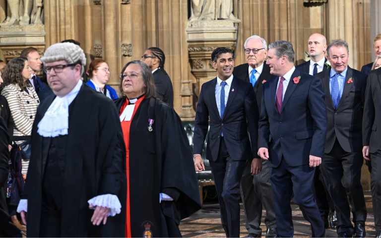 Rishi Sunak, Keir Starmer and other politicians walk through the Palace of Westminster.