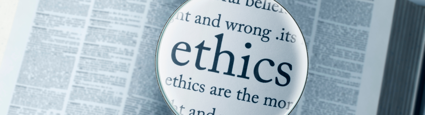 A magnifying glass hovering over a book, with the word "ethics" enlarged.