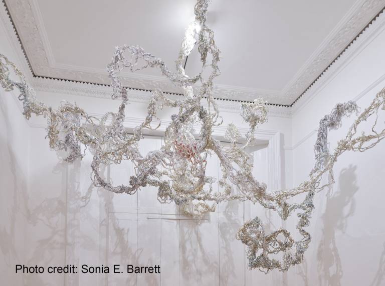 Dreading the map by Sonia E. Barrett: Large hanging sculpture made from shredded paper maps braided together in a white room