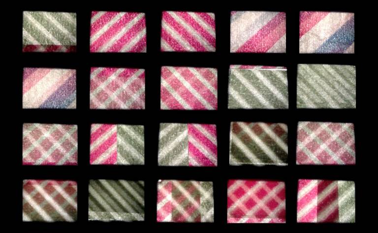 grid of brightly coloured patterned squares on a black background, taken from the Washi #2 film
