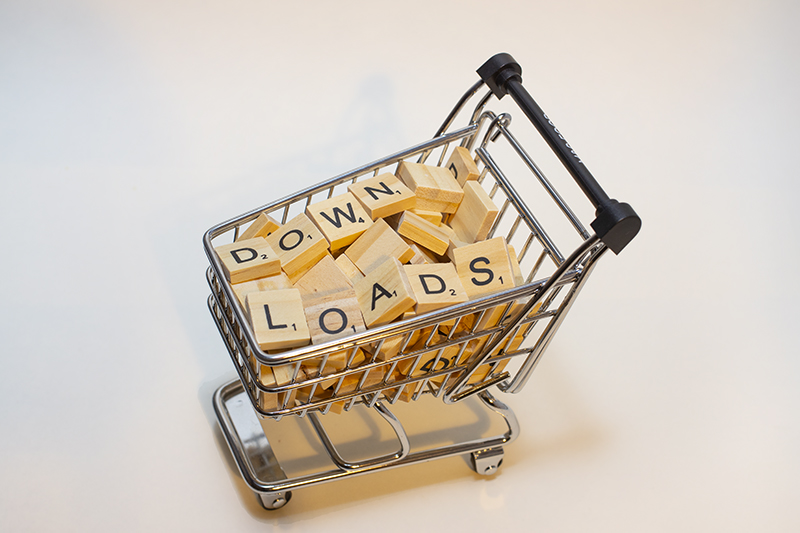 Downloads - Mini shopping trolley with wooden scrabble letters spelling downloads 