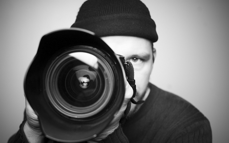 Photography and Images Help Teaser - Man hidden behind big pro camera lens