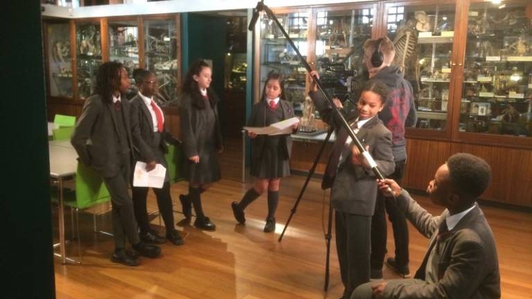 school students filming at the Grant Museum