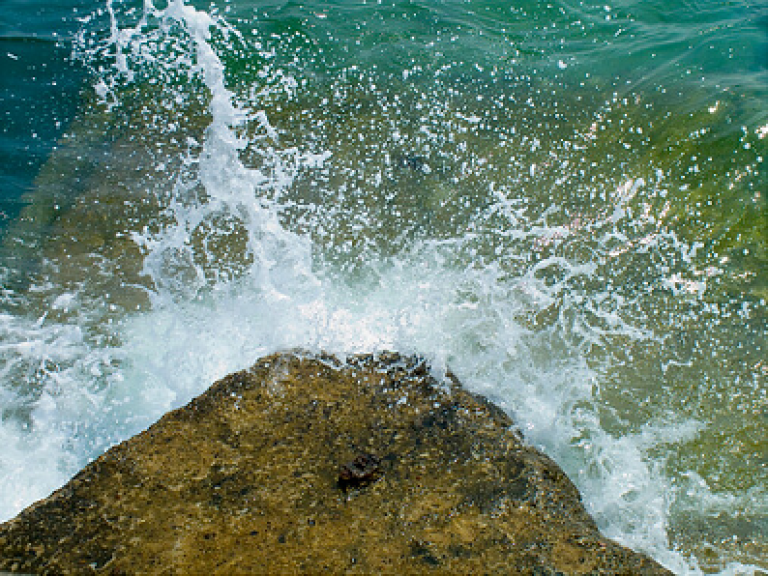 Waves from the sea smashing into a rock 