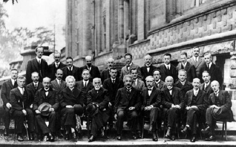 black and white photograph on male physicists wearing suits.