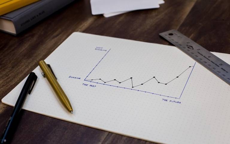 line graph on paper mapping out progress of future