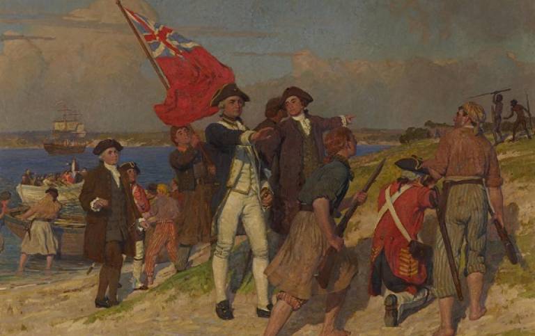Painting depicting Captain Cook landing in Botany bay. Cook and his crew of men are on the beach, in the back left there are ships in the sea, and in the far right there are two indigenous people with spears.