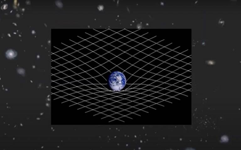 graphic of the universe. in the middle is a box with the planet earth and a grid. The grid bends where it meets the earth. 
