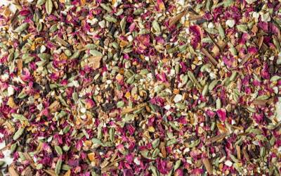 close up image of scattered seeds and petals. Pinks, greens and beige colours.